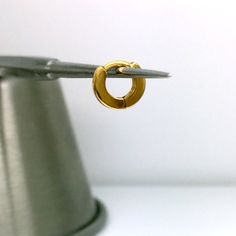 Teeny tiny 14K gold cartilage hoop earring for upper ear piercings. Sold as a single earring. This solid 14K yellow gold ear cartilage hoop earring is made in a brushed finish. Perfect for helix, tragus, Anti tragus, daith, or rook piercing. This earring is extremely small and may not fit everyone. Please check dimension carefully before placing an order. Product attributes Metal: high quality 14K solid gold Approximate inner diameter: 4mm Approximate outer diameter: 8mm Approximate width: 1.4mm Dainty Gold Huggie Piercings, Hypoallergenic Yellow Gold Piercings, Everyday Hypoallergenic Yellow Gold Piercings, Adjustable Minimalist Huggie Septum Ring, Nickel-free Minimalist Huggie Septum Ring, Tiny Gold Minimalist Huggie Earrings, Minimalist Internally Threaded Huggie Septum Ring, Everyday Internally Threaded Yellow Gold Cartilage Earrings, Dainty Gold Hypoallergenic Cartilage Earrings