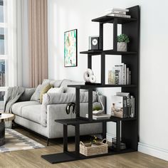 a living room with a couch, coffee table and bookshelf in the corner