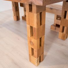 a wooden table and bench made out of wood planks on a white flooring