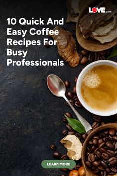 a cup of coffee sitting on top of a table next to some beans and leaves