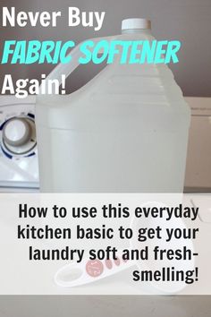 a gallon of fabric softener sitting on top of a counter next to a pair of scissors