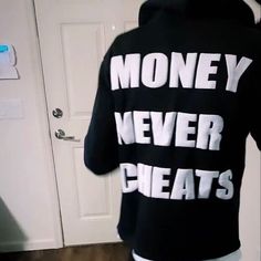 the back of a man's sweatshirt that says money never beats