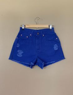 "High waisted 90's denim shorts. Made by Levi's in rare bright blue denim wash. Shorts are in excellent clean condition. Brand new with tags before I made them into cutoff shorts. These have been cutoff, distressed by hand, and washed once. Measurements are taken zipped or buttoned up and laid comfortably flat then x 2 for total circumference (inches) Tag Size 7 Levi's 560 100% Cotton Made in USA Waist 28\" Hips 42\" Length 13.5\" Inseam 2.5\" Rise 12\" leg opening circumference 26\" All items a 90s Inspired Denim Jean Shorts For Spring, 90s Inspired High Rise Blue Bottoms, 90s High-waist Cotton Jean Shorts, 90s Inspired Denim Jean Shorts For Summer, 90s Inspired Mid-rise Blue Bottoms, Blue Cutoff Jean Shorts With Pockets, Retro High Waist Medium Wash Shorts, 90s Inspired High Waist Cotton Jean Shorts, 90s Inspired High Rise Jean Shorts