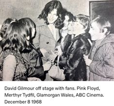 an old black and white photo of people in front of a mirror with the caption david gilour off stage with fans pink floyd