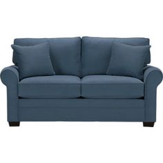 a blue couch with two pillows on it