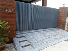 an entrance to a building with a metal gate and planters on the side walk