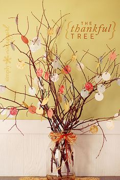 a vase filled with branches and paper hearts