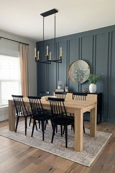 a dining room table surrounded by black chairs