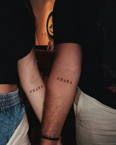 two people with tattoos on their legs and one has the word obama written on it