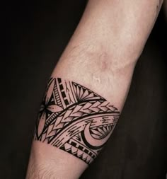 a man's arm with a tattoo on it that has an abstract design in black and white