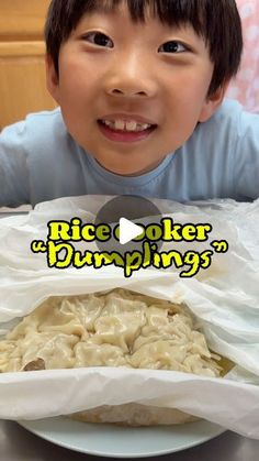 a little boy sitting in front of a white plate with food inside of it and the words rice cooker dumpings on top