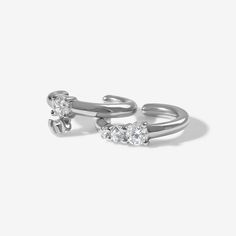 This crystal ear cuff set is about to become this seasons staple. Juana's dainty cubic zirconia crystal setting, wraps one ear cuff and swings from the other, adding a little luxe to your favorite look without all the OTT-ness. Pair it alongside a pretty crystal hoop earring for ultimate accessorizing. Created with a sterling silver base and utilizing luxury Rhodium plating, this Adorn Luxe earring is everything you love about our standard collection, but with a ‘demi-fine’ jewelry finish. Crystal Ear Cuff, Silver Ear Cuff, Crystal Hoop Earrings, Demi Fine Jewelry, Ear Cuffs, Rhodium Plated, Ear Cuff, Cubic Zirconia, Fine Jewelry