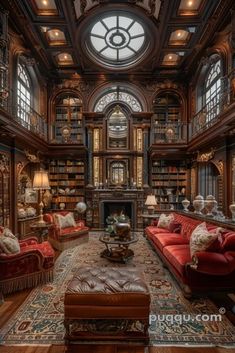 an ornate library with red couches and bookshelves in the center is lit by large windows