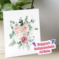 a white card with pink flowers on it next to a potted plant and the words support independent artists