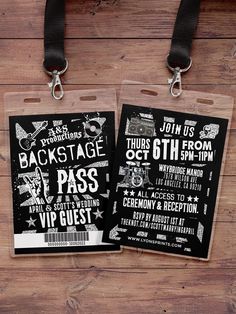 two luggage tags with black and white designs on them are attached to a wooden background