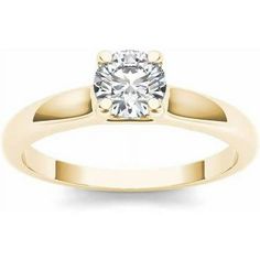 a yellow gold engagement ring with a round diamond in the center, on a white background