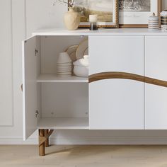 a white cabinet with plates and bowls on it