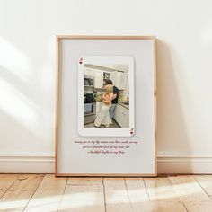 a photo frame with an image of a man and woman in the kitchen next to each other