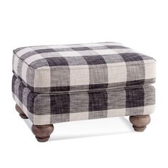 the footstool is made out of wood and plaid fabric