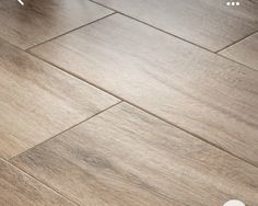 a wooden floor that has been cleaned and is laying on top of the floor next to a chair