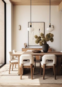 a dining room table with chairs and a vase on it