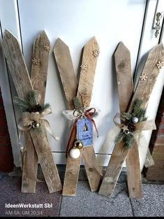 three wooden letters decorated with christmas decorations and bows on the front door's side