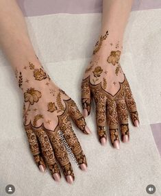 two hands with henna designs on them