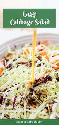 a salad with carrots, cabbage and parmesan cheese being drizzled over it