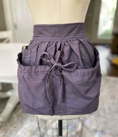 a mannequin with a purple skirt on it's back and two pockets in the front