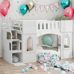 a white castle bed with balloons and confetti on the floor next to it