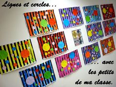 the wall is decorated with colorful paper circles and dots on striped strips in different colors