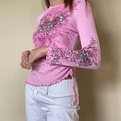 Be a y2k butterfly princess with this fitter pink top with ruffled edges and ruched details. Material: Polyester and Spandex Small: Bust: 80-84 Waist: 68 Length: 52 Sleeve: 56 Medium: Bust: 84-88 Waist: 72 Length: 53 Sleeve: 57 Large: Bust: 88-92 Waist: 76 Length: 54 Sleeve: 58 Pink Y2k Style Tops For Spring, Pink Y2k Tops For Spring, Pink Fitted Y2k Style Top, Fitted Barbiecore Tops, Pink Y2k Style Party Tops, Pink 90s Style Spring Tops, Fitted Long Sleeve Tops With Butterfly Print, Trendy Pink Butterfly Print Tops, Fitted Butterfly Print Tops For Spring