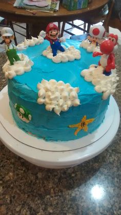 there is a blue cake with mario and other characters on it