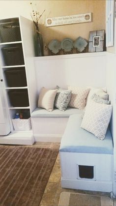 a room with a couch, bookshelf and rugs on the floor in front of it