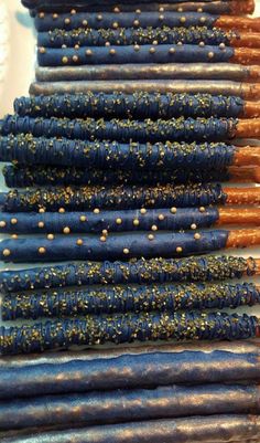 several blue and gold colored candles are lined up