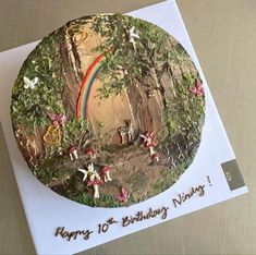 a birthday card with an image of a rainbow in the forest on it's side