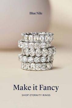 an advertisement for blue nile jewelry featuring three rings and the words make it fancy shop eternity rings