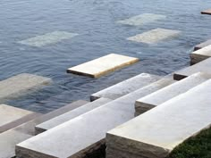 concrete blocks sitting on the edge of a body of water