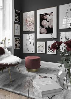 a living room filled with lots of pictures and flowers on the wall next to a window