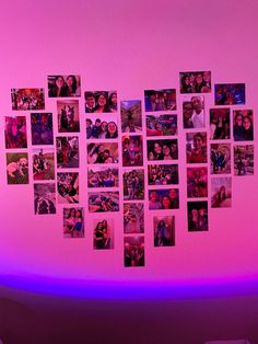 a wall with many pictures on it and purple lighting in the corner behind it is a bed