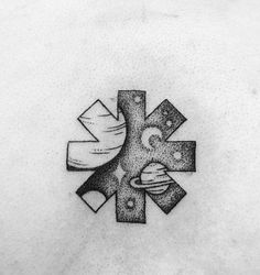 a black and white photo of a cross tattoo