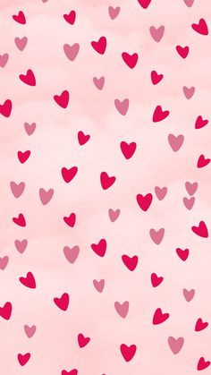 pink and red hearts flying in the air on a light pink background with white clouds