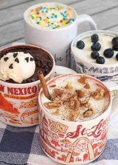 three different types of desserts in cups on a table