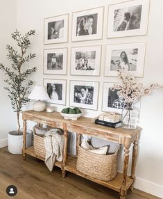 a wooden table topped with baskets under pictures