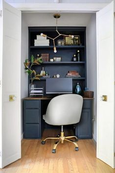 an office area with a desk, chair and bookshelf in the corner is shown