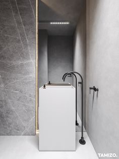 a bathroom with a sink, shower head and faucet in the middle of it