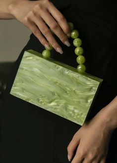 Introducing the Bead Handle Acrylic Mini Box Bag; an exclusive and elegant addition to any wardrobe. The box bag is adorned with a luxurious bead handle, crafted from beautiful acrylic, and showcases a stunning green hue. An elegant and tasteful must-have. Green Rectangular Box Bag For Party, Trendy Green Box Bag For Party, Rectangular Green Box Bag For Evening, Green Rectangular Box Bag For Evening, Green Clutch Evening Bag, Green Clutch Box Bag As Gift, Green Clutch Box Bag For Gifts, Formal Handheld Green Box Bag, Elegant Green Bag