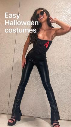 a woman in black leather pants posing for the camera