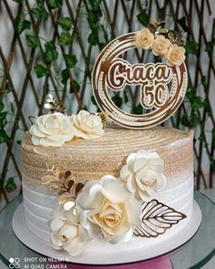 a close up of a cake on a table with white flowers and an inscription that reads crazy 50