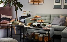 a living room filled with lots of furniture and food on top of a coffee table